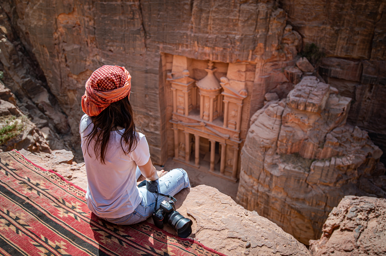 Asian woman traveler sitting in Petra, Jordan